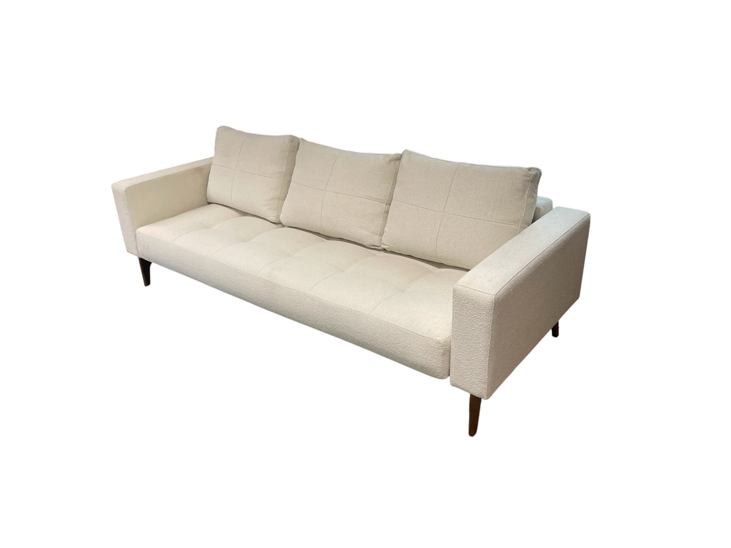 Magpie Reclamations mid-century modern sofa in cream textured fabric with tufted cushions and tapered wooden legs.