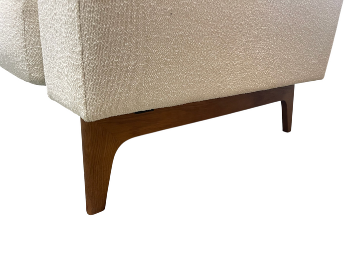 Magpie Reclamations cream textured fabric sofa with tapered wooden legs on a blue patterned rug