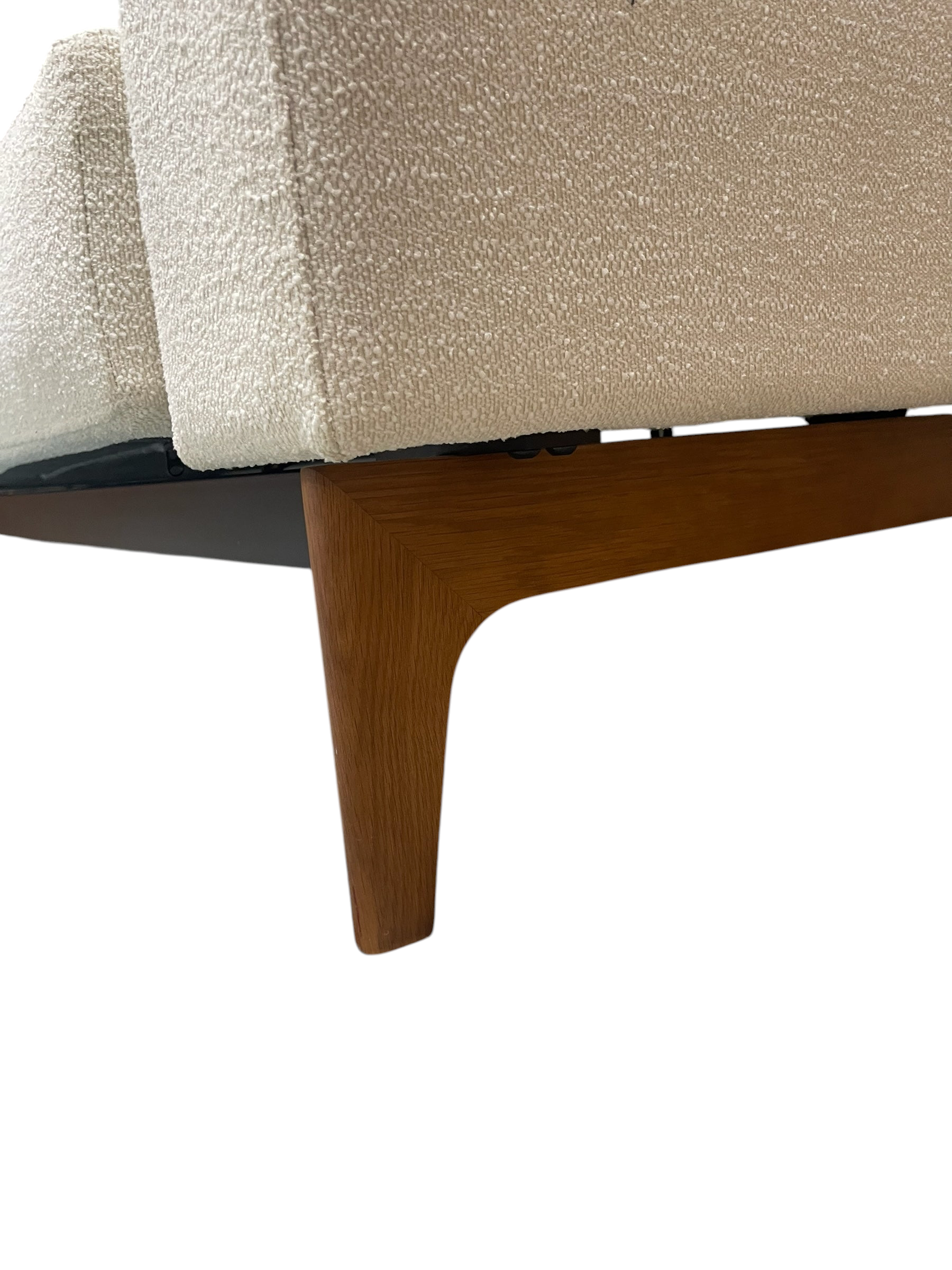 Magpie Reclamations mid-century modern sofa with textured cream fabric and tapered wooden legs on a blue rug