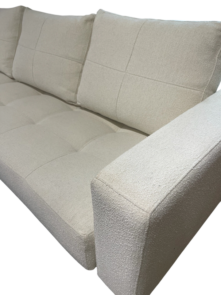 Magpie Reclamations mid-century modern sofa in textured cream fabric with tufted cushions and clean minimalist lines.