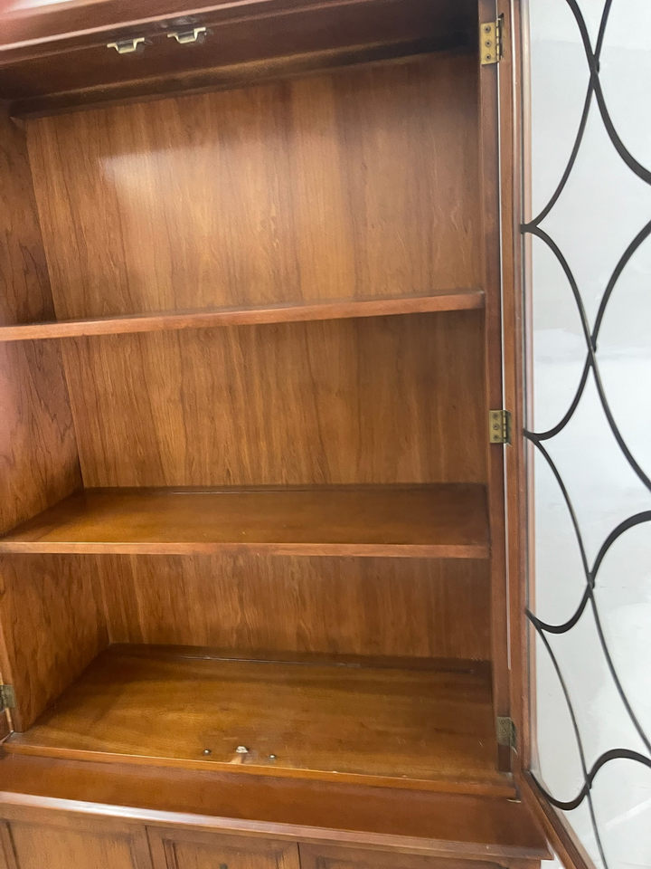 Magpie Reclamations traditional wooden china cabinet hutch featuring glass doors with intricate lattice overlay.
